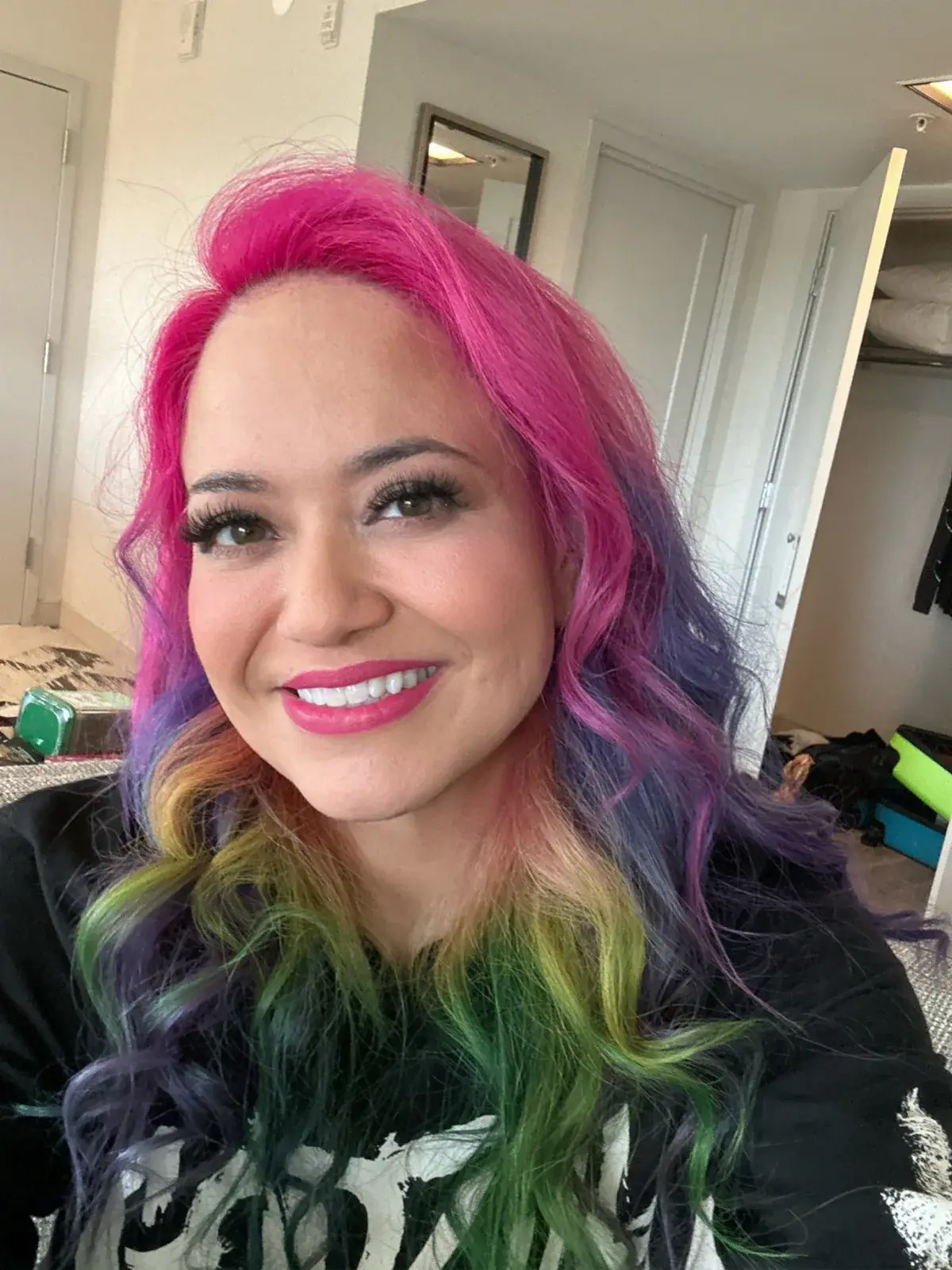 Tommy Brunswick smiling with vivid pink, purple and green hair