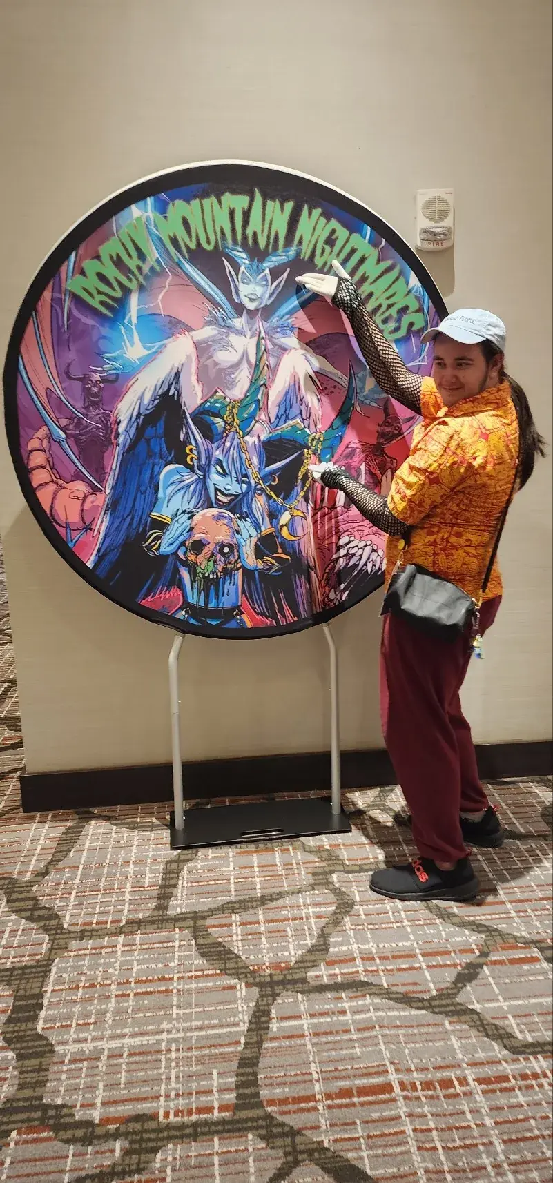 An attendee beside a Rocky Mountain Nightmares event display