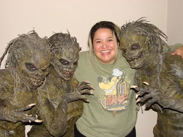 Tommy Brunswick standing with two practical creatures during the production of Born of Earth