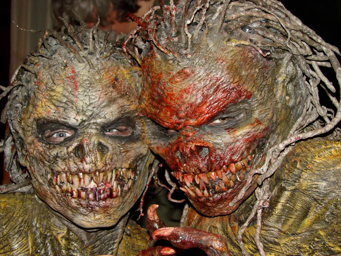 Two practical creature costumes from Born of Earth, with textured skin, teeth and tangled tendrils