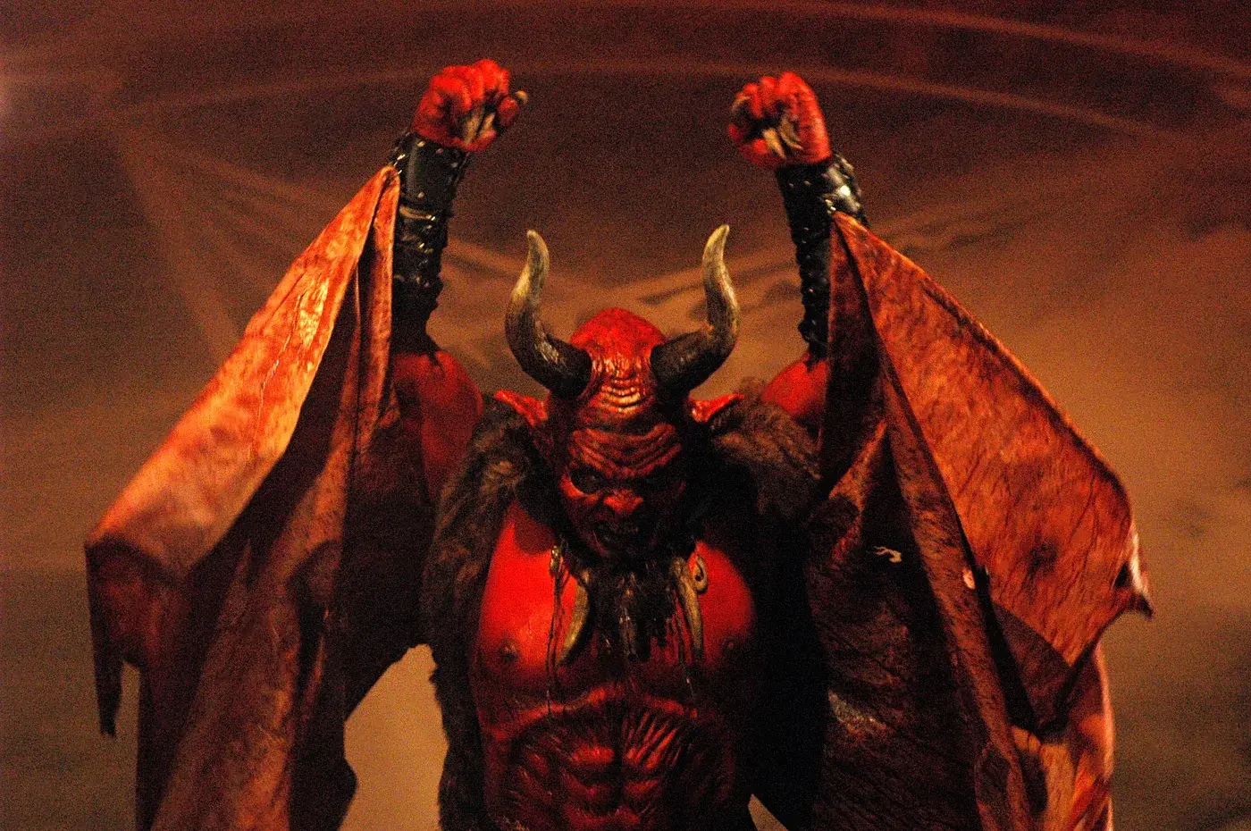 The horned red creature costume from Little Red Devil with its large wings raised