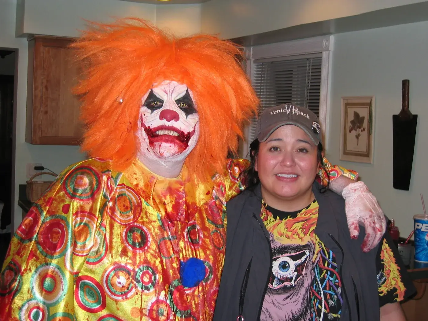 Tommy Brunswick beside Mr. Jingles in orange hair, clown makeup and a colorful costume during production